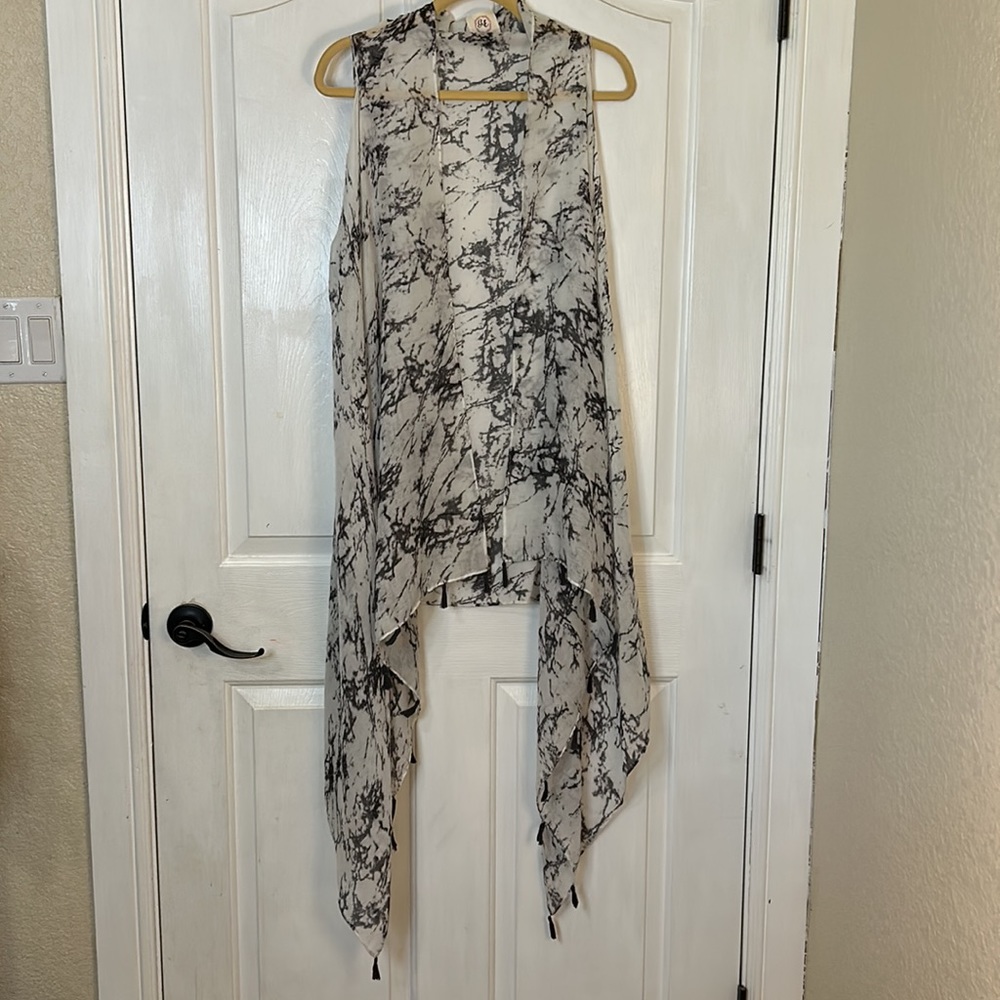 Grace & Emma sheer asymmetrical hem vest in marbled gray and white. Gray tassels